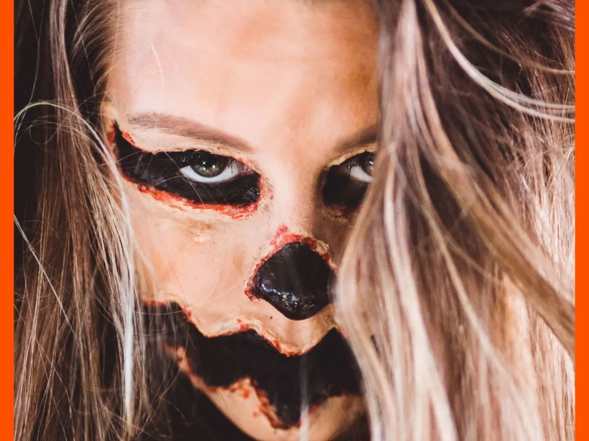 Cette photo montre une personne avec un maquillage d'halloween effrayant sur le visage.