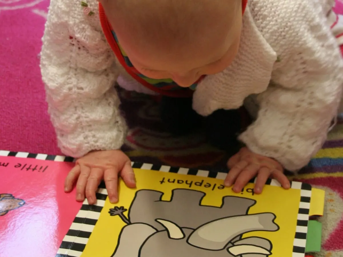Un bébé avec un livre.